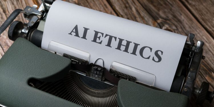 Üzerinde AI Ethics yazan bir kağıt takılı eski tip yeşil daktilo.